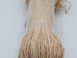 a roll of twine of twine on a white surface