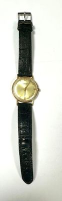 a watch that is sitting on a white surface