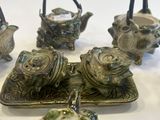 five pieces of pottery sitting on a table