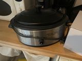 a crock pot sitting on a counter next to a microwave