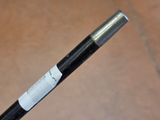 a black and white stick with a white label on it