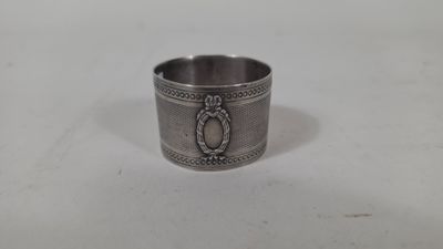 a close up of a silver ring on a white surface