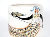 a white vase with a painting of a woman on it