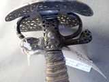 a silver sword with a bird on it and a tag attached to it