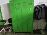 a green locker in the corner of a room with a chair