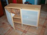a small cabinet with a glass door on the floor