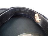 a close up of a black hat with a broken brimle on it