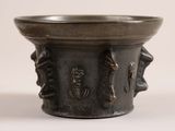 a small metal bowl with a design on it