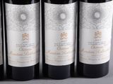 four bottles of wine are lined up on a table