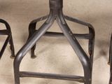 three stools and a table in a room