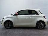 a small white car that is parked in a parking lot