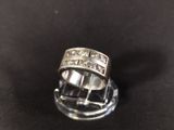 a close up of a diamond ring on a black surface
