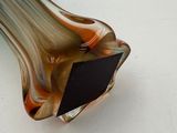 a glass vase that has a black and brown design on it