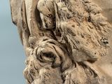 a close up of a statue with a bird on it ' s head