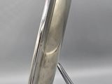 a silver plate on a metal stand on a white background