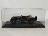 an old model of a black car in a clear display case