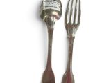 two forks and a spoon sitting next to each other