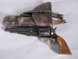 an old gun with a leather holster on a white background