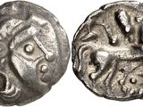 a silver coin with an image of a horse on it
