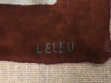 an image of a red and white rug with the letter e on it