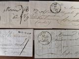 three old envelopes are sitting on top of a wooden table