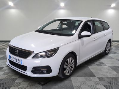 the white car is parked on a checkered floor in the garage