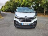 the front view of a white van parked on the side of a road