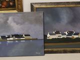 three paintings of houses on a shelf next to a painting