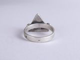 a close up of a silver ring on a white surface