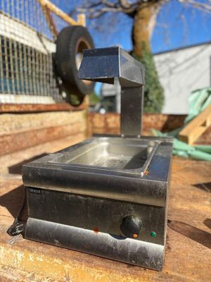 a small stove that is sitting on a wooden table