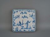 a blue and white plate with birds and flowers on it
