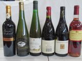 several bottles of wine are lined up on a table