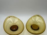 pair of yellow glass candlesticks with a brown center