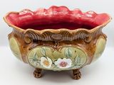 a large bowl with flowers on it sitting on a table