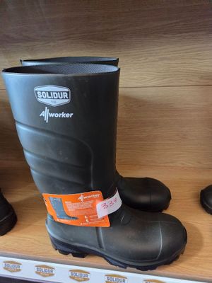 pair of black rubber boots on a shelf in a store