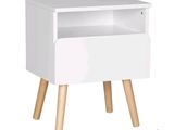 a close up of a white nightstand with wooden legs