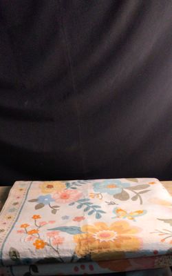 a stack of folded towels sitting on top of a wooden table