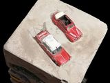 two toy cars sitting on top of a stack of books