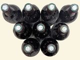 several bottles of wine are arranged in a circle on a white surface