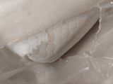 a close up picture of a pillow on a bed