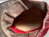a close up of a baseball cap with a hole in it
