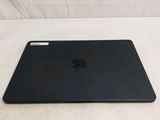 a black apple laptop sitting on a white surface