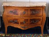 a marble top chest of drawers in a room
