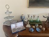 a table with a lot of silver and glass items on it