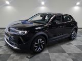 un SUV noir garé sur un sol à damier dans un showroom