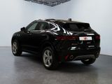 the rear end of a black suv parked in a garage