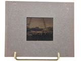 an old picture frame with a picture of a sunset in the background