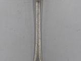a close up of a spoon with a spoon handle on a table