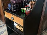 a bar cart with drinks on it in the kitchen