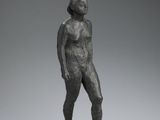 an image of a bronze statue of a woman standing on a black base